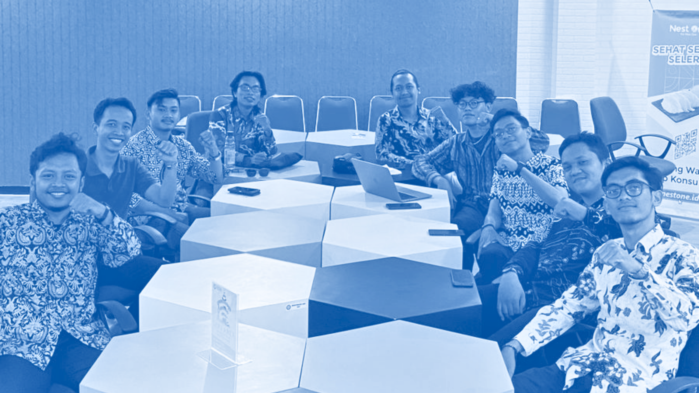 The RekanMU team gathered around a conference table.